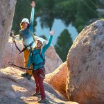 Two climbers waving hello on the Tahoe Via Ferrata